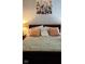 Close up of a comfortable bedroom with wood-trimmed bed and plush pillows at 450 Columbia Ct, Greenwood, IN 46142