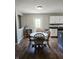 Cozy dining area with wood floors, a round table with chairs, and natural light from a nearby window at 450 Columbia Ct, Greenwood, IN 46142