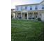 Well-manicured lawn leading to a charming two-story home with white picket fence and covered porch at 450 Columbia Ct, Greenwood, IN 46142