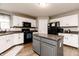 Bright kitchen featuring white cabinets, a central island, and modern appliances at 450 Columbia Ct, Greenwood, IN 46142