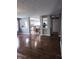 Open-concept living space showcasing hardwood floors, a view into the kitchen and ample natural light at 450 Columbia Ct, Greenwood, IN 46142