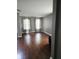 Bright living room featuring hardwood floors and sheer curtains at 450 Columbia Ct, Greenwood, IN 46142