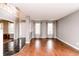 Bright and airy living room with hardwood floors, large windows, and an open staircase at 450 Columbia Ct, Greenwood, IN 46142