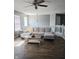 Cozy living room with a comfortable couch, natural light, and modern ceiling fan at 450 Columbia Ct, Greenwood, IN 46142