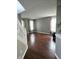 Open living room with wood floors, large windows and a staircase at 450 Columbia Ct, Greenwood, IN 46142