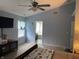 View of a main bedroom showcasing an ensuite bath, tv, and ceiling fan at 450 Columbia Ct, Greenwood, IN 46142