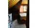 Attic bedroom features wood paneling, natural light from a window, and carpeted floors, creating a cozy retreat at 4850 E University Ave, Indianapolis, IN 46201