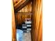 Attic closet with exposed wooden beams and ample space for storage, ensuring efficient use of space at 4850 E University Ave, Indianapolis, IN 46201