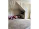 Cozy attic space with unique architectural details and a carpeted floor, perfect for a playroom or storage at 4850 E University Ave, Indianapolis, IN 46201