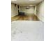Spacious unfinished basement area with concrete and laminate flooring and white walls at 4850 E University Ave, Indianapolis, IN 46201