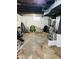 Unfinished basement with concrete floor, exposed ductwork, and small window for natural light at 4850 E University Ave, Indianapolis, IN 46201