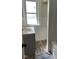 Bathroom with modern vanity, wood floors, and a window offering natural light and fresh appeal at 4850 E University Ave, Indianapolis, IN 46201