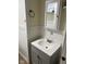 Bathroom featuring gray vanity, a classic towel ring, and framed mirror, for a comfortable and tidy space at 4850 E University Ave, Indianapolis, IN 46201