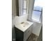 Bathroom with modern gray vanity, bright window, and sleek fixtures, offering comfort and style at 4850 E University Ave, Indianapolis, IN 46201