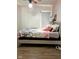 Bright bedroom with a queen bed, white walls, and soft lighting, creating an inviting personal space at 4850 E University Ave, Indianapolis, IN 46201