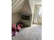 Cozy attic bedroom with natural light, featuring unique architectural details at 4850 E University Ave, Indianapolis, IN 46201