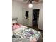 Comfortable bedroom with a floral accent bedspread, closet and overhead lighting, providing a serene space to rest at 4850 E University Ave, Indianapolis, IN 46201