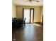 Inviting dining area with wood-look flooring and a modern table set, illuminated by natural light from the door at 4850 E University Ave, Indianapolis, IN 46201