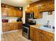 Well-equipped kitchen featuring wood cabinets and stainless steel appliances at 4850 E University Ave, Indianapolis, IN 46201