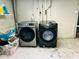 Side-by-side, front-load Samsung washer and dryer in the unfinished basement laundry area at 4850 E University Ave, Indianapolis, IN 46201