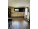 Spacious living room with hardwood floors, large windows, and modern decor, for gatherings and relaxation at 4850 E University Ave, Indianapolis, IN 46201