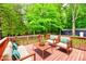 Cozy outdoor seating arrangement on a wooden deck, overlooking a lush wooded backyard at 504 W Gold Creek Rd, Mooresville, IN 46158