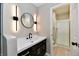 Modern bathroom featuring updated lighting, a vanity, and a shower behind sliding glass doors at 504 W Gold Creek Rd, Mooresville, IN 46158
