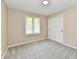 Neutral bedroom featuring soft carpeting, a window for natural light, and closet space at 504 W Gold Creek Rd, Mooresville, IN 46158