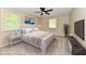 Bright bedroom features a modern ceiling fan, sleek tv and large windows for lots of natural light at 504 W Gold Creek Rd, Mooresville, IN 46158