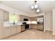 Well-lit kitchen boasts stainless steel appliances, updated cabinets, and modern fixtures at 504 W Gold Creek Rd, Mooresville, IN 46158