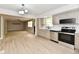 Spacious kitchen with stainless steel appliances, tile backsplash, and wood-look floors at 504 W Gold Creek Rd, Mooresville, IN 46158