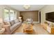 Staged living room featuring comfortable seating, modern decor, and wood-look flooring at 504 W Gold Creek Rd, Mooresville, IN 46158