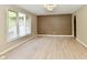 Light-filled living room showcasing wood-look floors, decorative wall, and neutral color scheme at 504 W Gold Creek Rd, Mooresville, IN 46158
