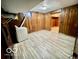 A basement with wood paneling, vinyl flooring, and a laundry area at 5222 Nob Ln, Indianapolis, IN 46226