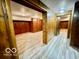 An open basement area features wood paneling, vinyl flooring, and ample space at 5222 Nob Ln, Indianapolis, IN 46226