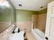 Traditional bathroom featuring a bathtub, shower, and neutral colored tiled walls at 5222 Nob Ln, Indianapolis, IN 46226