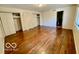 Bedroom featuring hardwood floors, a closet with sliding doors, and an ensuite bathroom at 5222 Nob Ln, Indianapolis, IN 46226