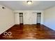 A bedroom that boasts polished hardwood floors and ample closet space at 5222 Nob Ln, Indianapolis, IN 46226
