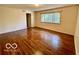 Spacious bedroom featuring hardwood floors and natural light through the windows at 5222 Nob Ln, Indianapolis, IN 46226