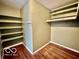 Organized closet with built-in shelves and hardwood floors at 5222 Nob Ln, Indianapolis, IN 46226