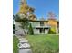 Charming home featuring a well-manicured lawn, stone accents, and a cozy second-story balcony at 5222 Nob Ln, Indianapolis, IN 46226