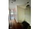 Bright hallway with hardwood floors, leading to a staircase with elegant railing at 5222 Nob Ln, Indianapolis, IN 46226