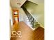 Entryway with tiled flooring and a staircase featuring a decorative metal railing at 5222 Nob Ln, Indianapolis, IN 46226
