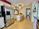 Eat-in kitchen featuring stainless steel refrigerator and center island with breakfast bar at 5222 Nob Ln, Indianapolis, IN 46226