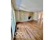 Empty living room featuring a stone fireplace, hardwood floors, and natural light at 5222 Nob Ln, Indianapolis, IN 46226
