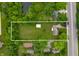Aerial view of property highlighting expansive lot with mature trees, detached building and ample space at 5330 W 56Th St, Indianapolis, IN 46254