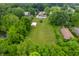 Drone photo showcases homes surrounded by lush greenery and a barn at 5330 W 56Th St, Indianapolis, IN 46254