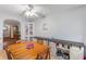 Bright dining area boasts a farmhouse-style buffet, white display cabinet, and modern ceiling fan at 5330 W 56Th St, Indianapolis, IN 46254