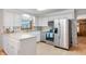 Well-lit kitchen equipped with stainless steel appliances, light countertops and plentiful cabinet space at 5330 W 56Th St, Indianapolis, IN 46254