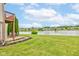 Spacious backyard with green lawn, patio seating, and serene lake view at 5372 Bay Harbor Dr, Indianapolis, IN 46254